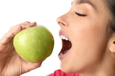 Photo of Young woman with healthy teeth and apple on white background, closeup