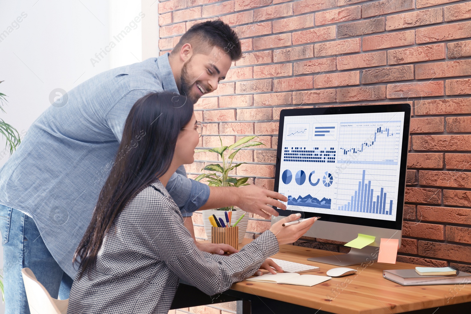 Image of Colleagues working on computer in office. Fintech concept