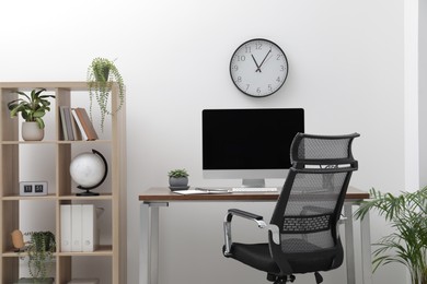 Workspace with desk, chair and computer at home