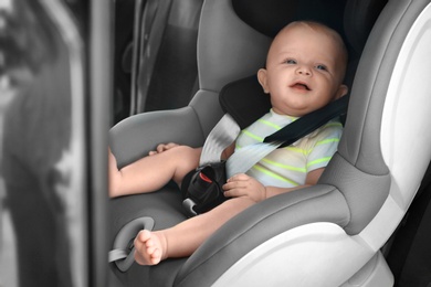 Photo of Little baby in child safety seat inside of car