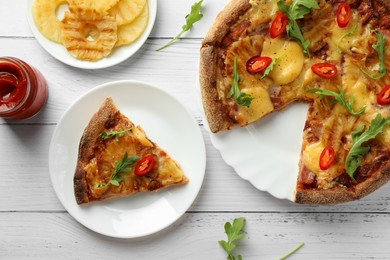 Photo of Delicious Hawaiian pizza with pineapple and ingredients on white wooden table, flat lay