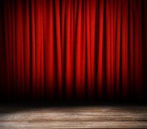 Image of Empty wooden stage and closed red curtains