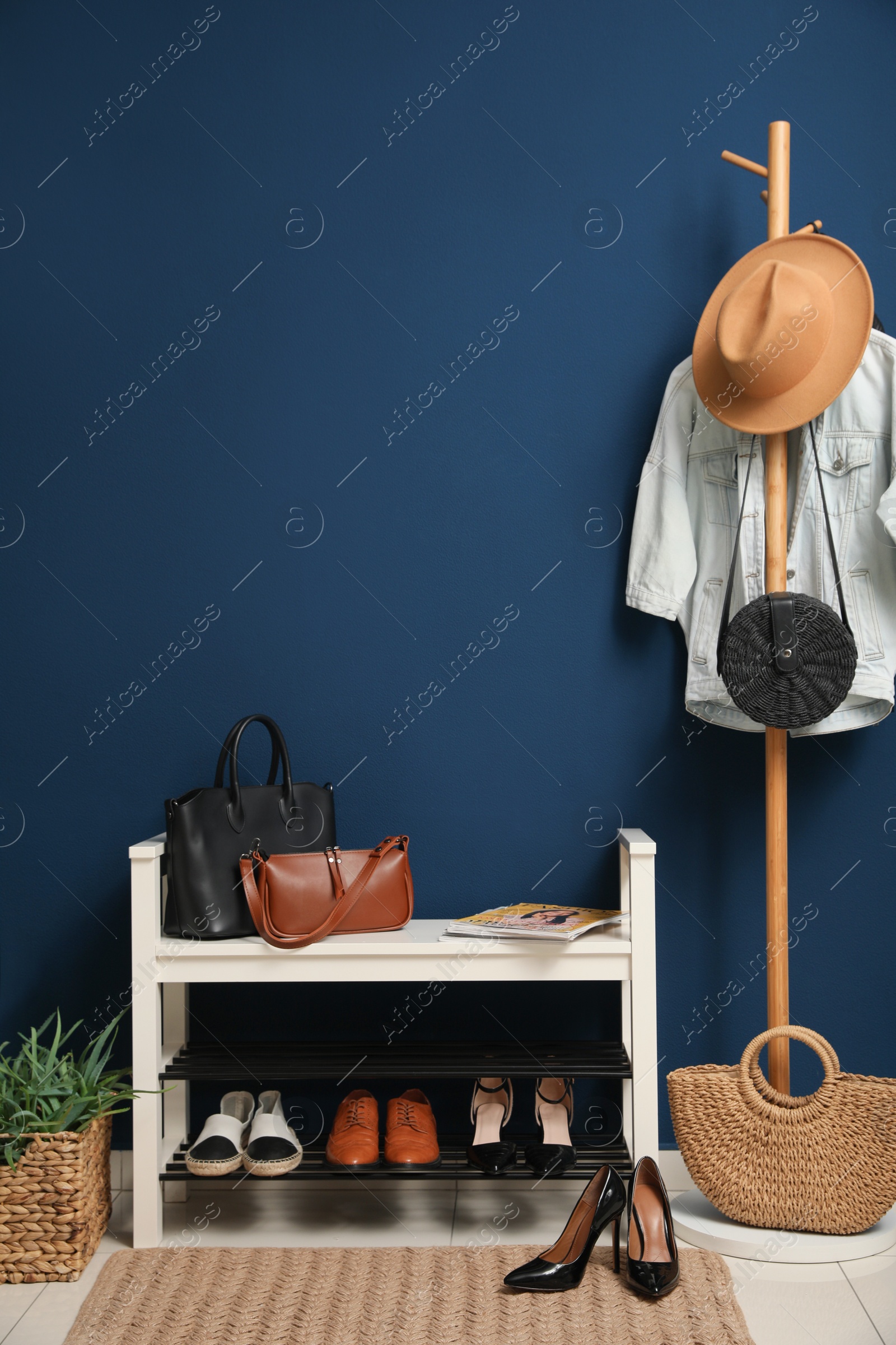 Photo of Hallway interior with stylish furniture, clothes and accessories