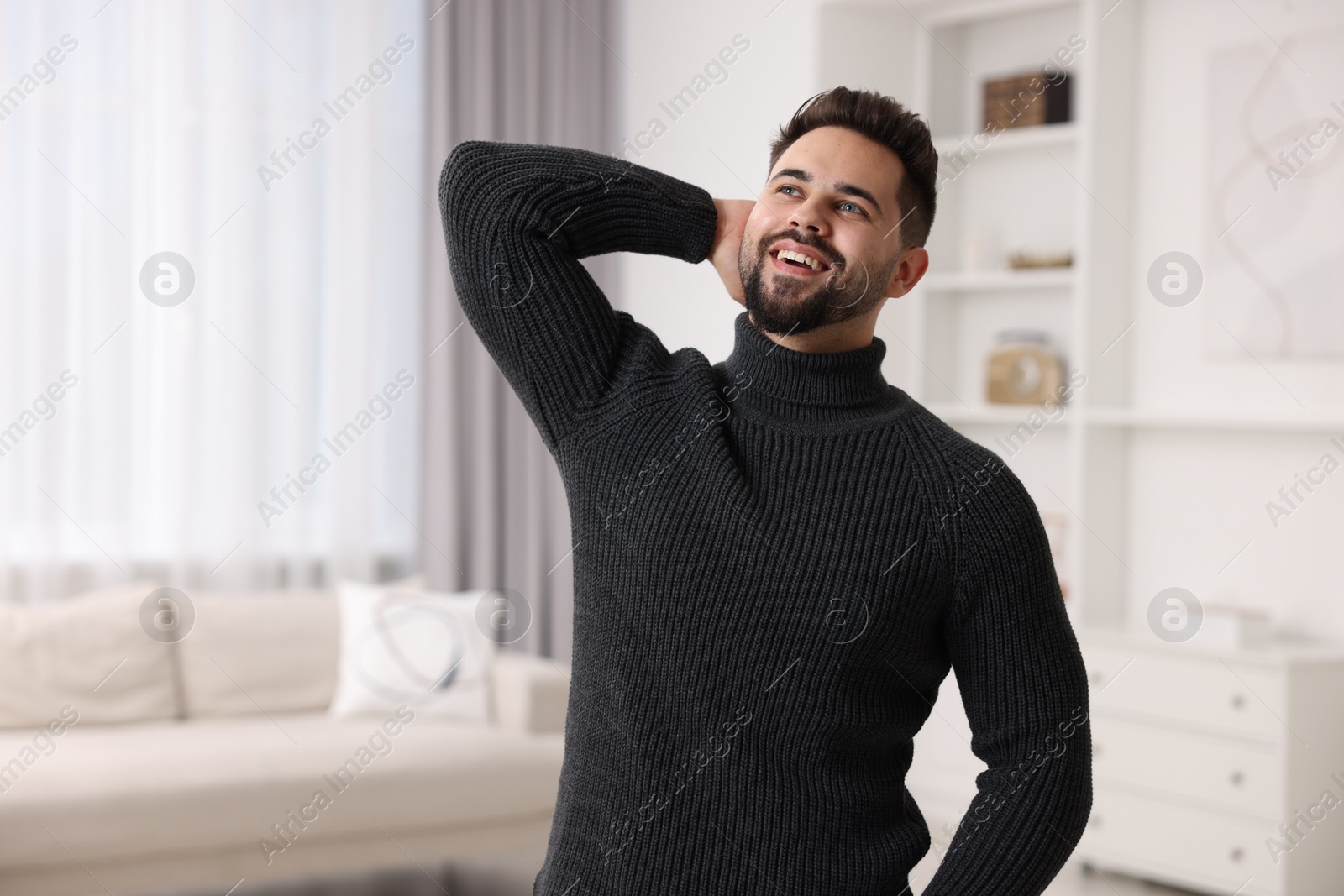 Photo of Happy man in stylish sweater at home