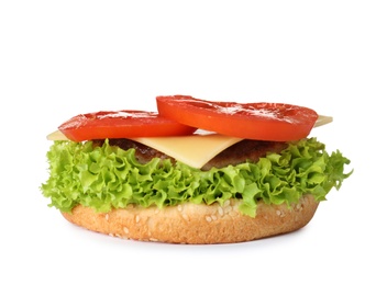 Photo of Burger bun with cutlet and vegetables isolated on white