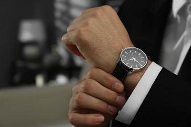 Photo of Businessman with luxury wrist watch indoors, closeup