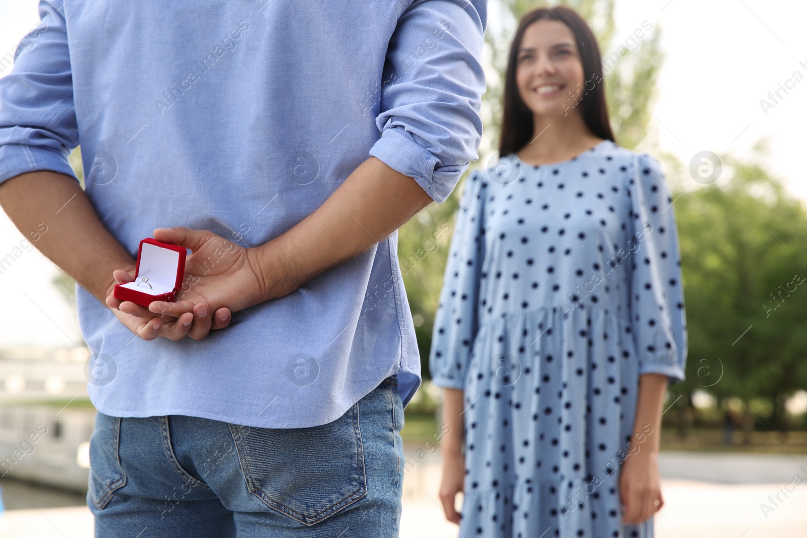 Photo of Man with engagement ring making proposal to his girlfriend outdoors, closeup