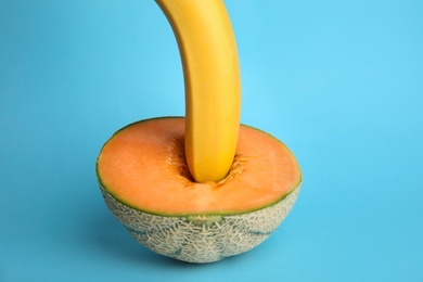 Photo of Fresh banana and melon on blue background. Sex concept