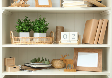 Photo of White shelving unit with different decorative elements