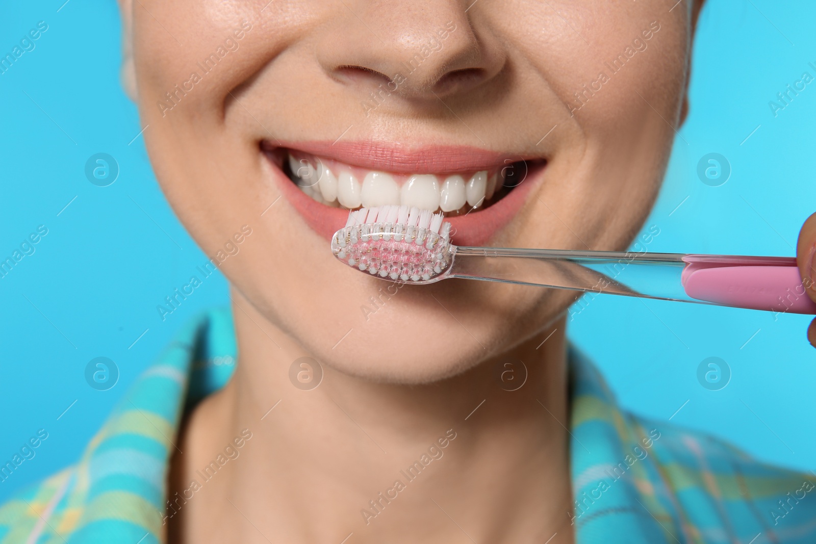 Photo of Woman with toothbrush on color background, closeup