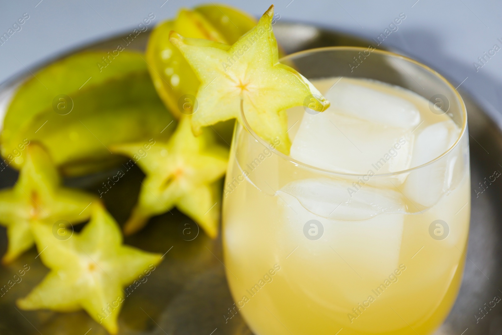 Photo of Delicious carambola juice in glass, closeup. Space for text