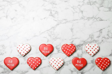 Valentine's day cookies on white marble table, flat lay. Space for text