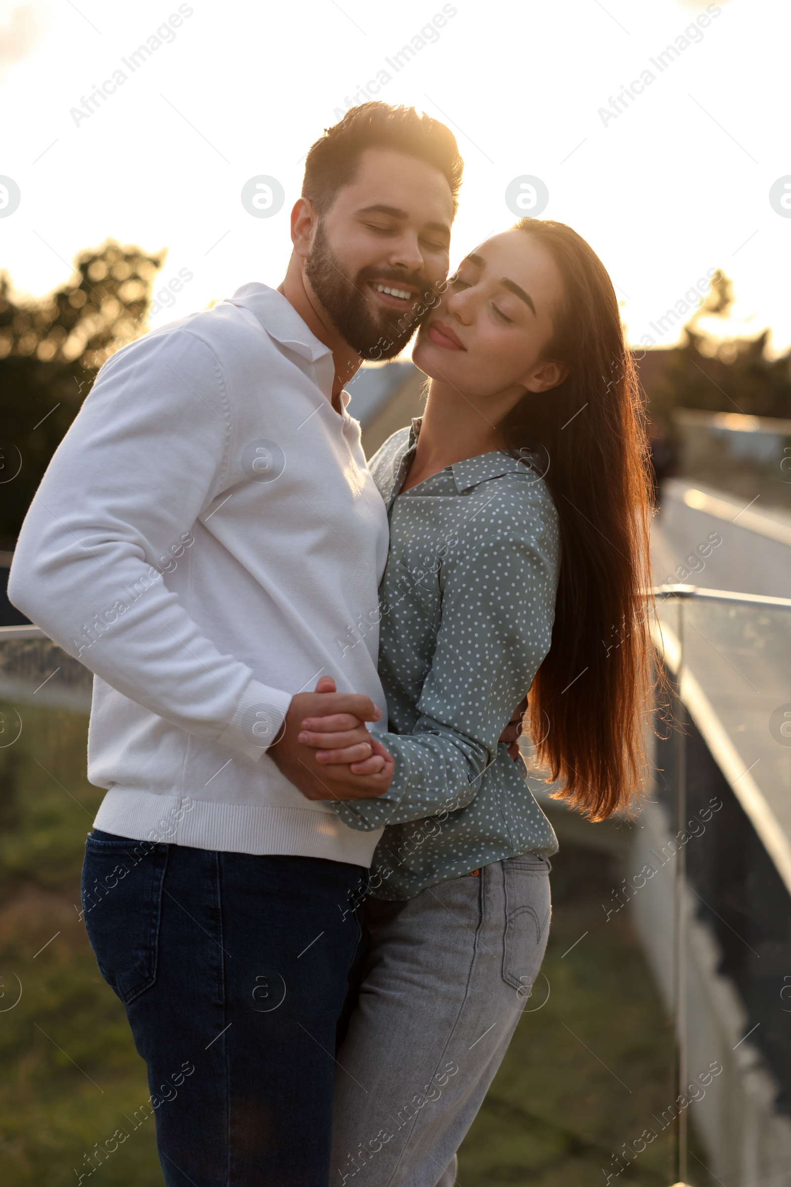 Photo of Lovely couple dancing together outdoors at sunset