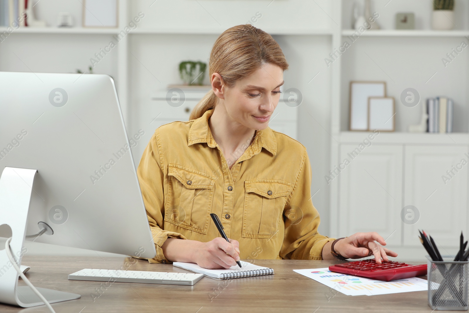 Photo of Professional accountant working at wooden desk in office