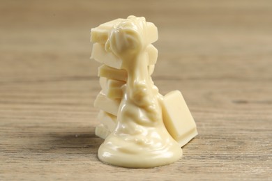 Pieces of white chocolate and tasty paste on wooden table, closeup