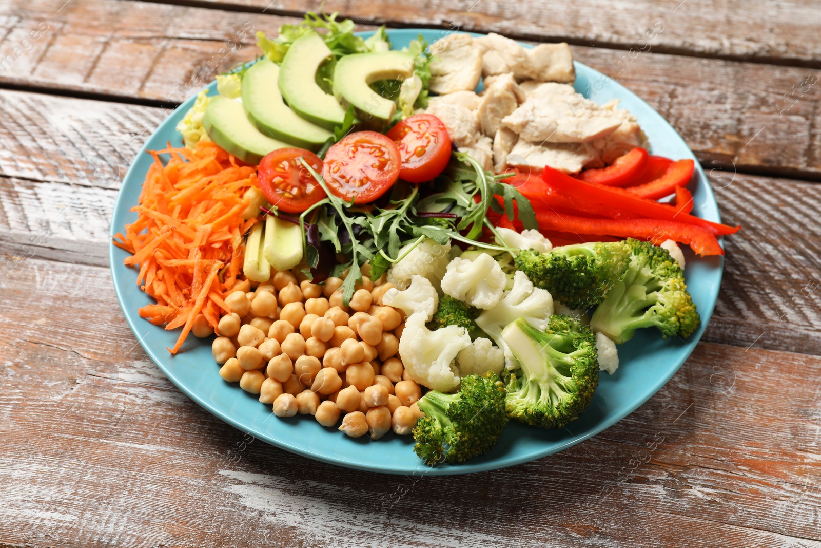 Photo of Balanced diet and healthy foods. Plate with different delicious products on wooden table