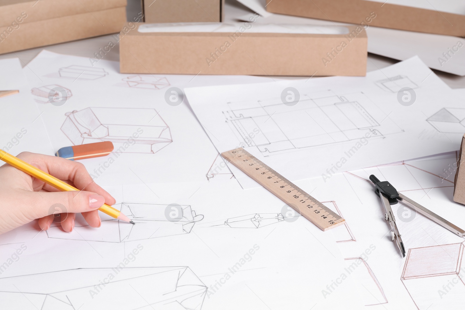 Photo of Woman creating packaging design at table, closeup