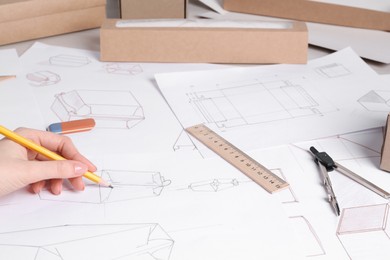 Woman creating packaging design at table, closeup