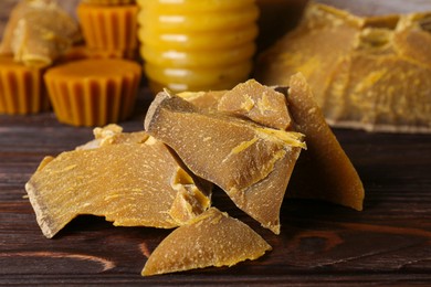 Photo of Natural beeswax blocks on wooden table, closeup