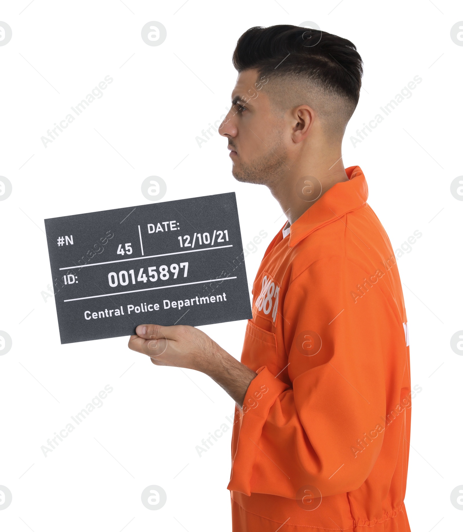 Photo of Mug shot of prisoner in orange jumpsuit with board on white background, side view