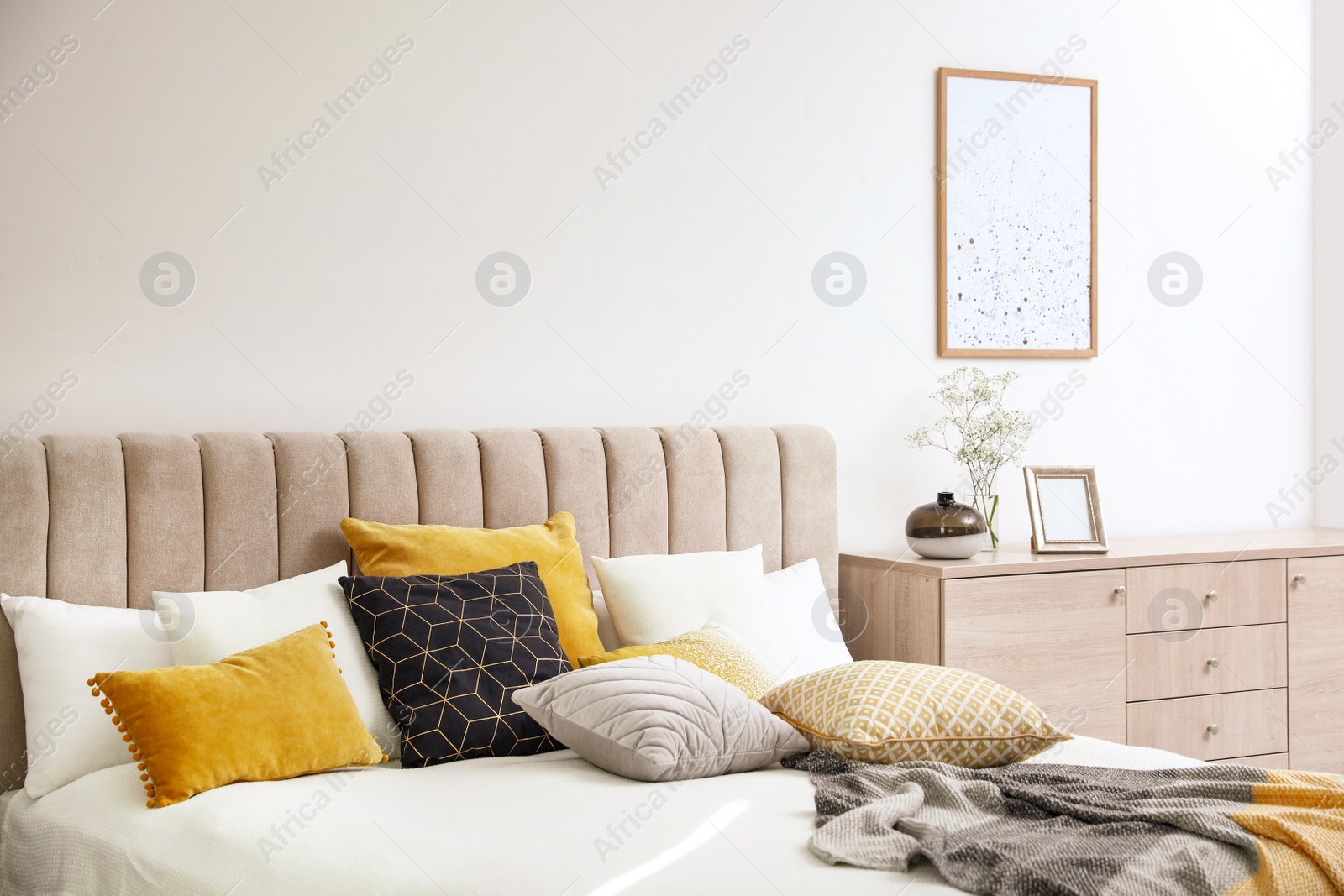 Photo of Comfortable bed with soft pillows in stylish room interior