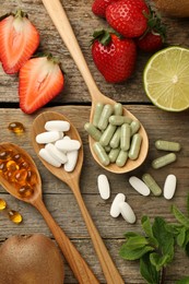 Photo of Different vitamin pills and fresh fruits on old wooden table, flat lay