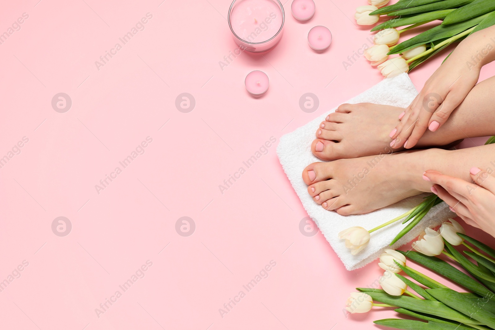 Photo of Closeup of woman with neat toenails after pedicure procedure on pink background, top view. Space for text