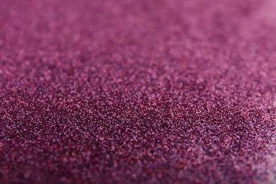 Photo of Closeup view of sparkling violet glitter background