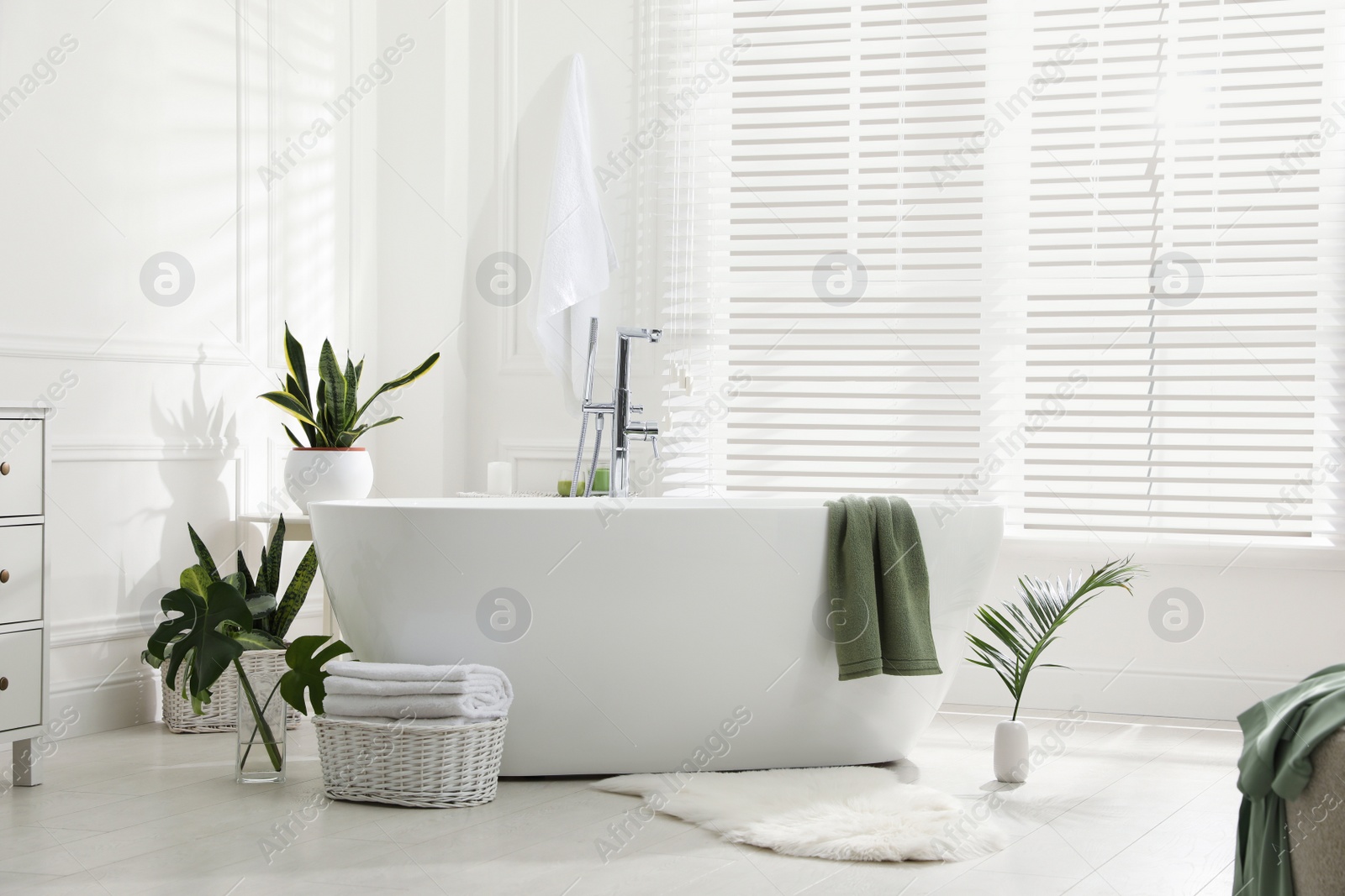 Photo of Stylish bathroom interior with green plants. Home design