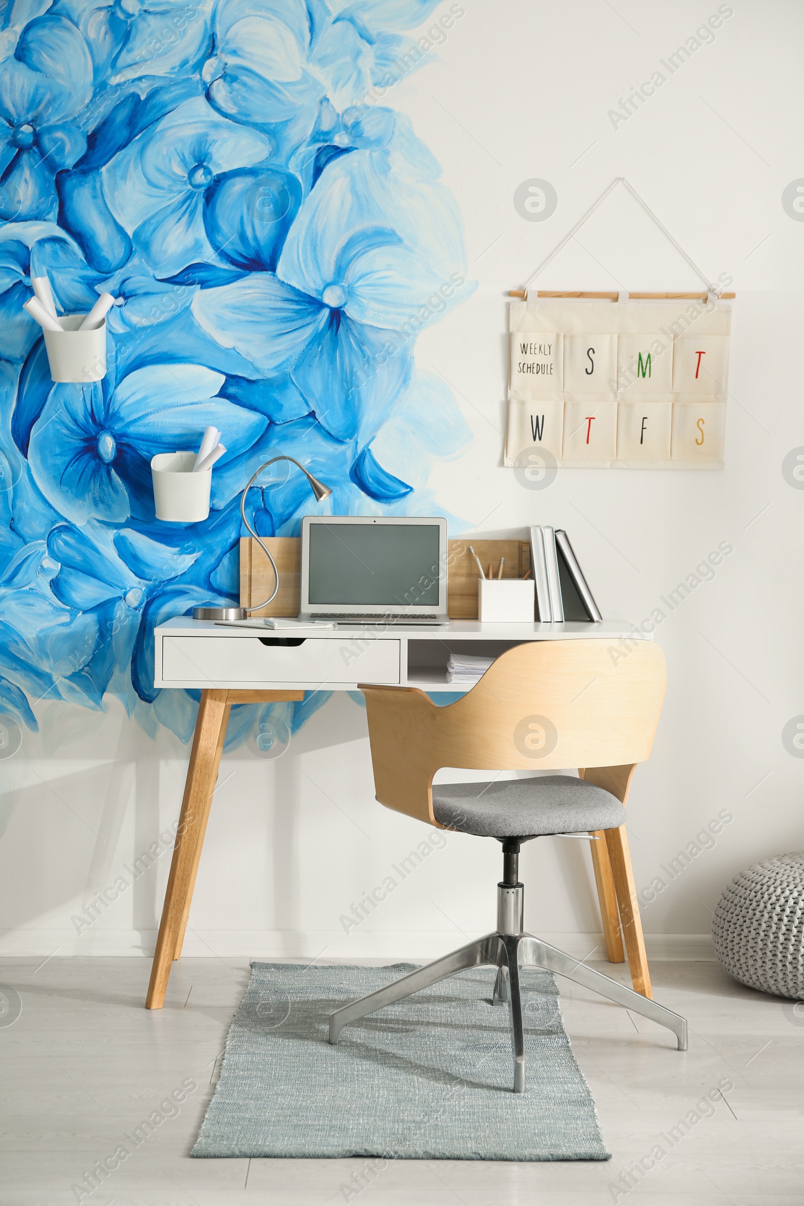 Photo of Stylish living room interior with blue flowers painted on wall. Floral pattern