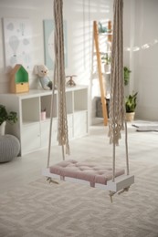 Beautiful swing in room. Stylish interior design