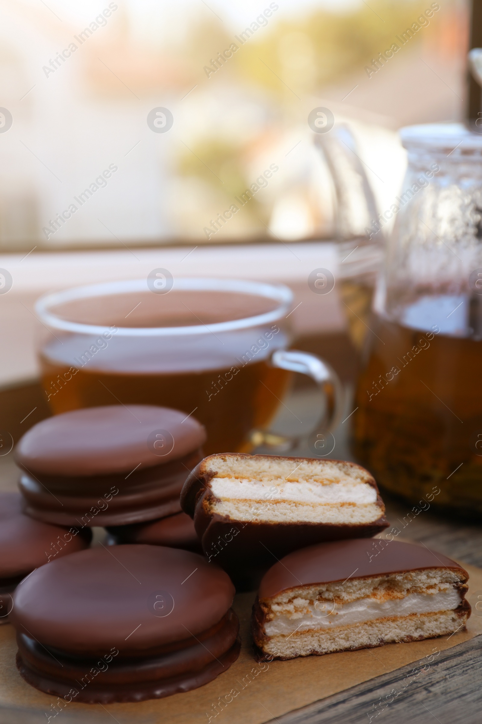 Photo of Tasty choco pies and tea on wooden tray
