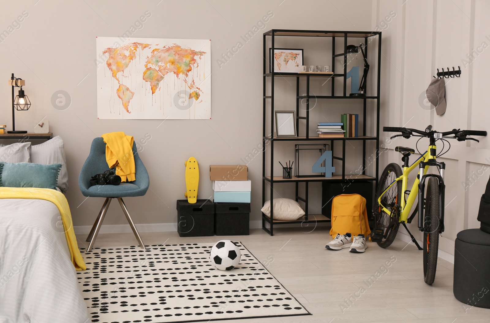 Photo of Stylish teenager's room interior with comfortable bed and sports equipment