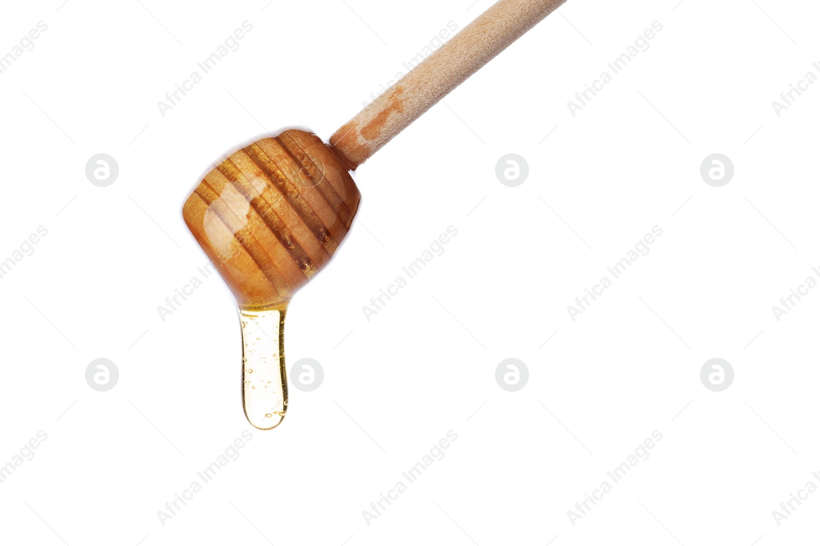 Photo of Honey dripping from wooden dipper isolated on white