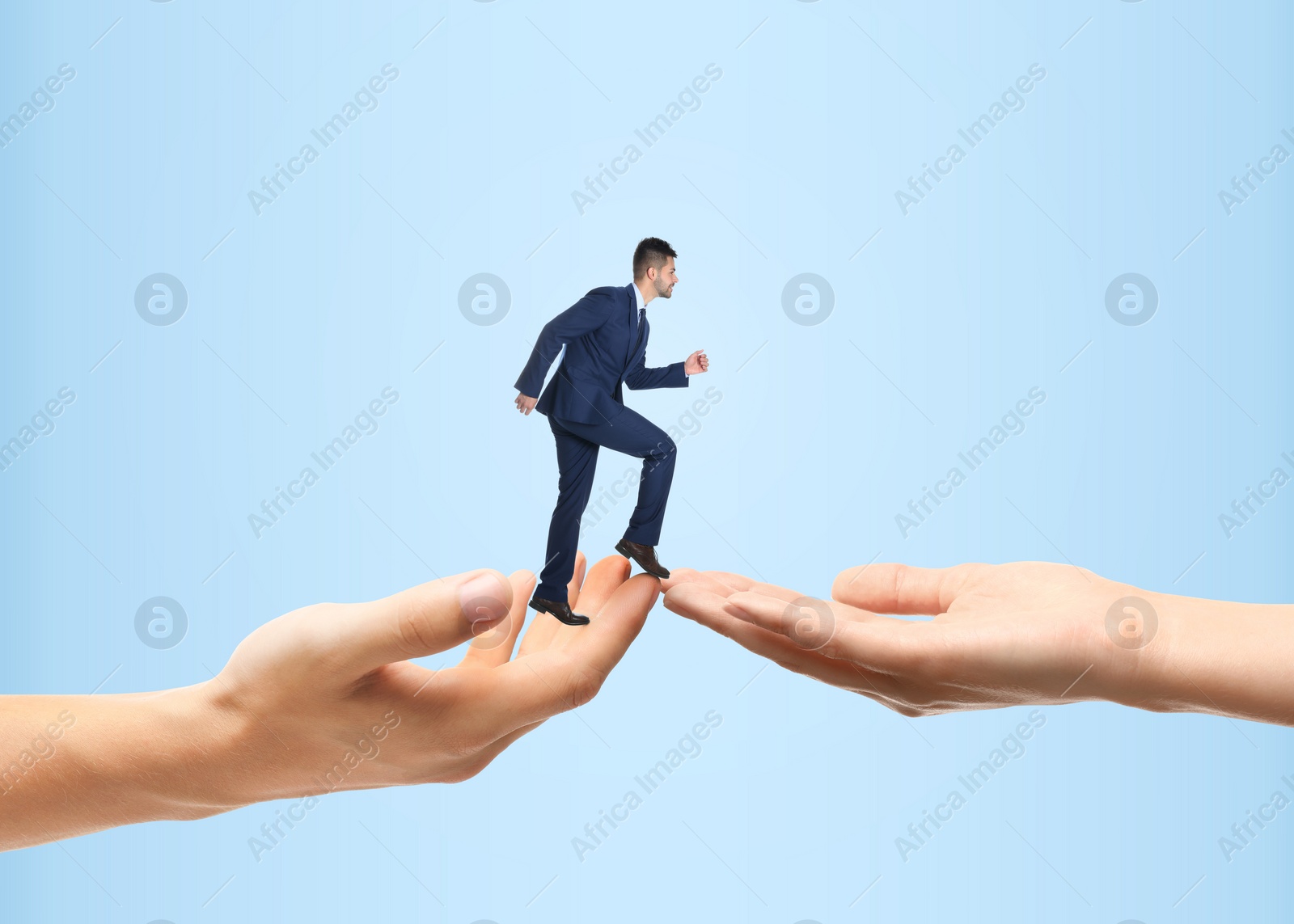 Image of Support or partnership concept. People joining hands as bridge to help businessman walk forward