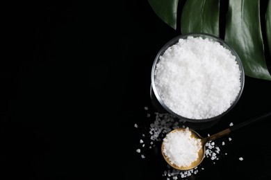 Photo of Bowl and spoon with natural sea salt on mirror table, flat lay. Space for text