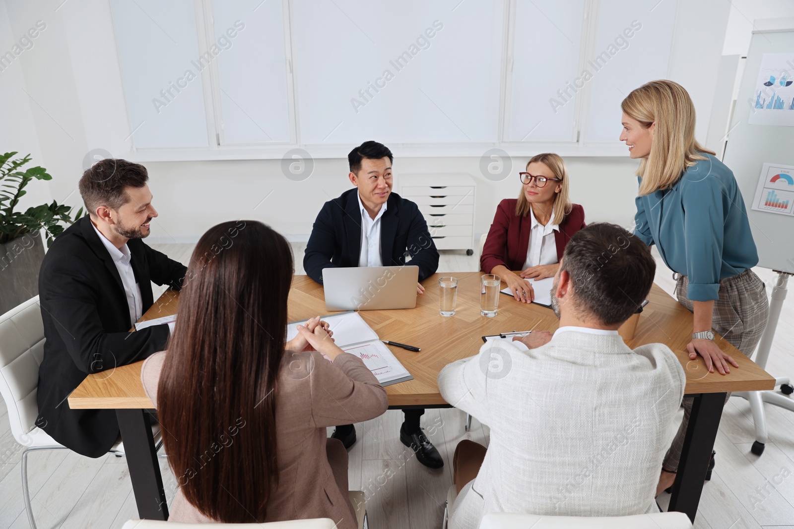 Photo of Businesswoman having meeting with her employees in office