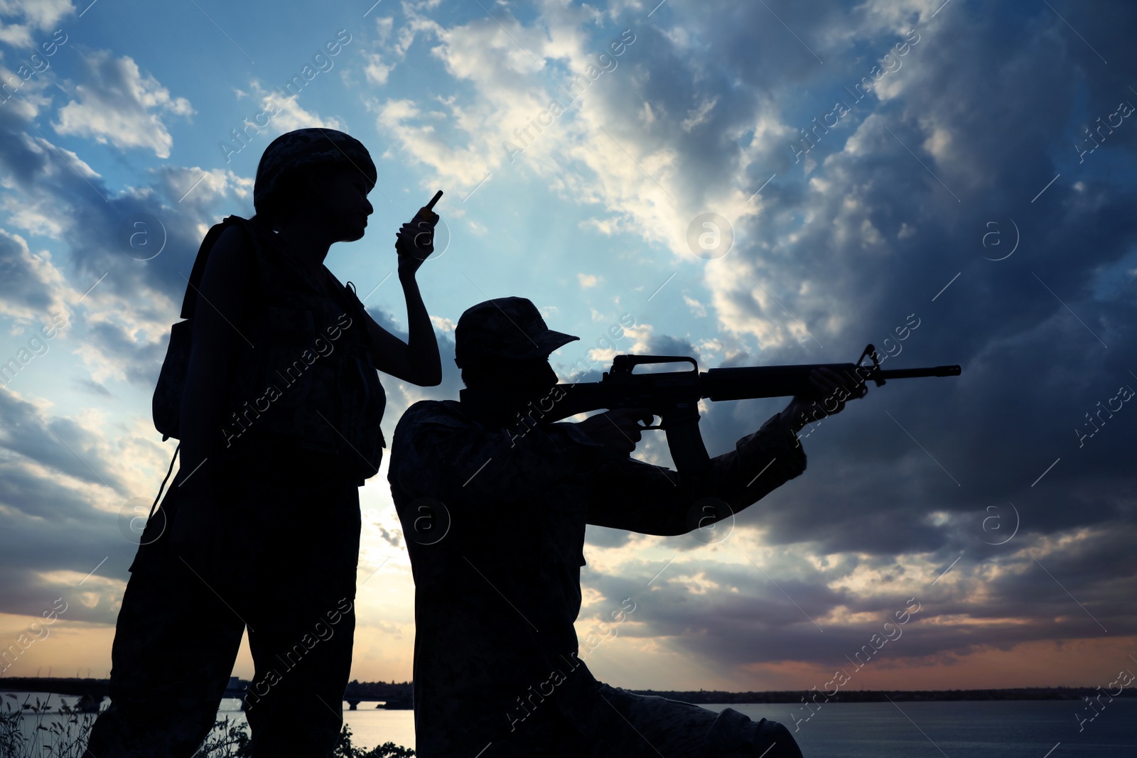 Photo of Soldiers in uniform patrolling outdoors. Military service