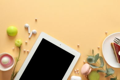 Flat lay composition with tablet on beige background. Food blogger's workplace