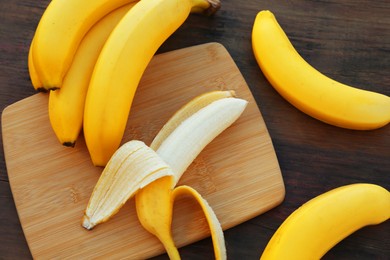 Delicious bananas on wooden table, flat lay