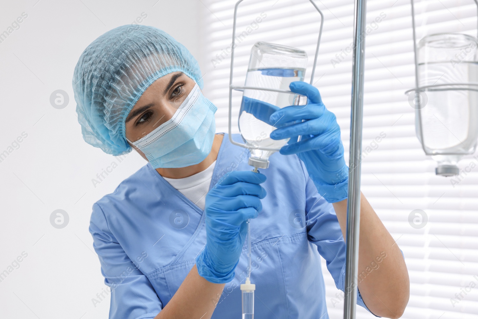 Photo of Nurse setting up IV drip in hospital