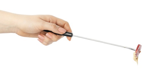 Photo of Tasty fondue. Woman holding fork with salami and melted cheese on white background, closeup