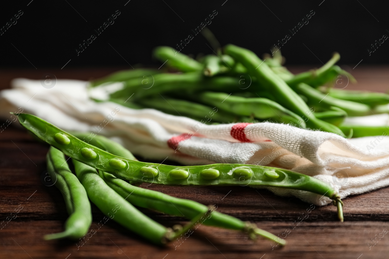 Photo of Fresh green beans on wooden table, closeup