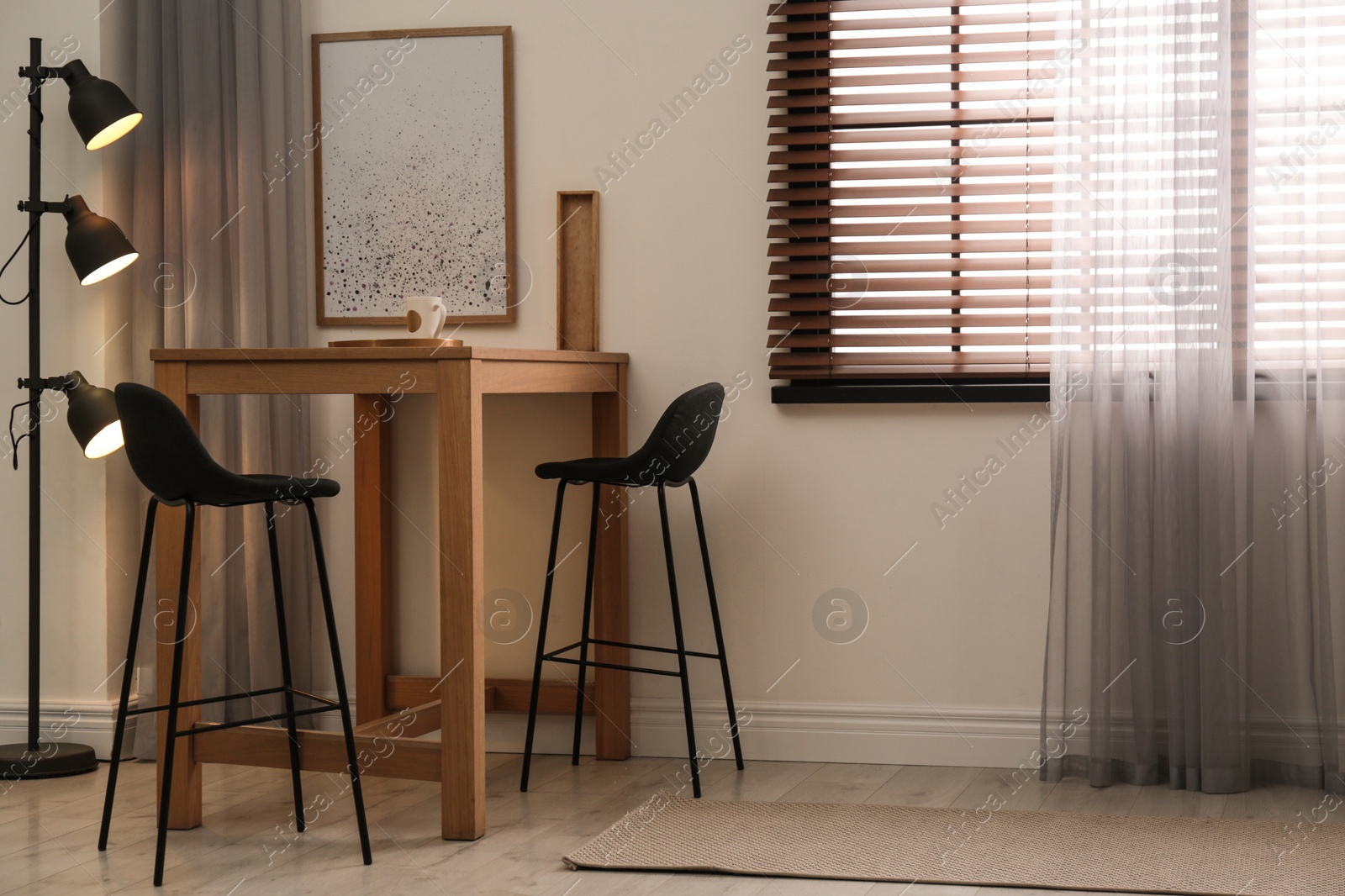 Photo of Modern room interior with table set, window blinds and stylish decor elements