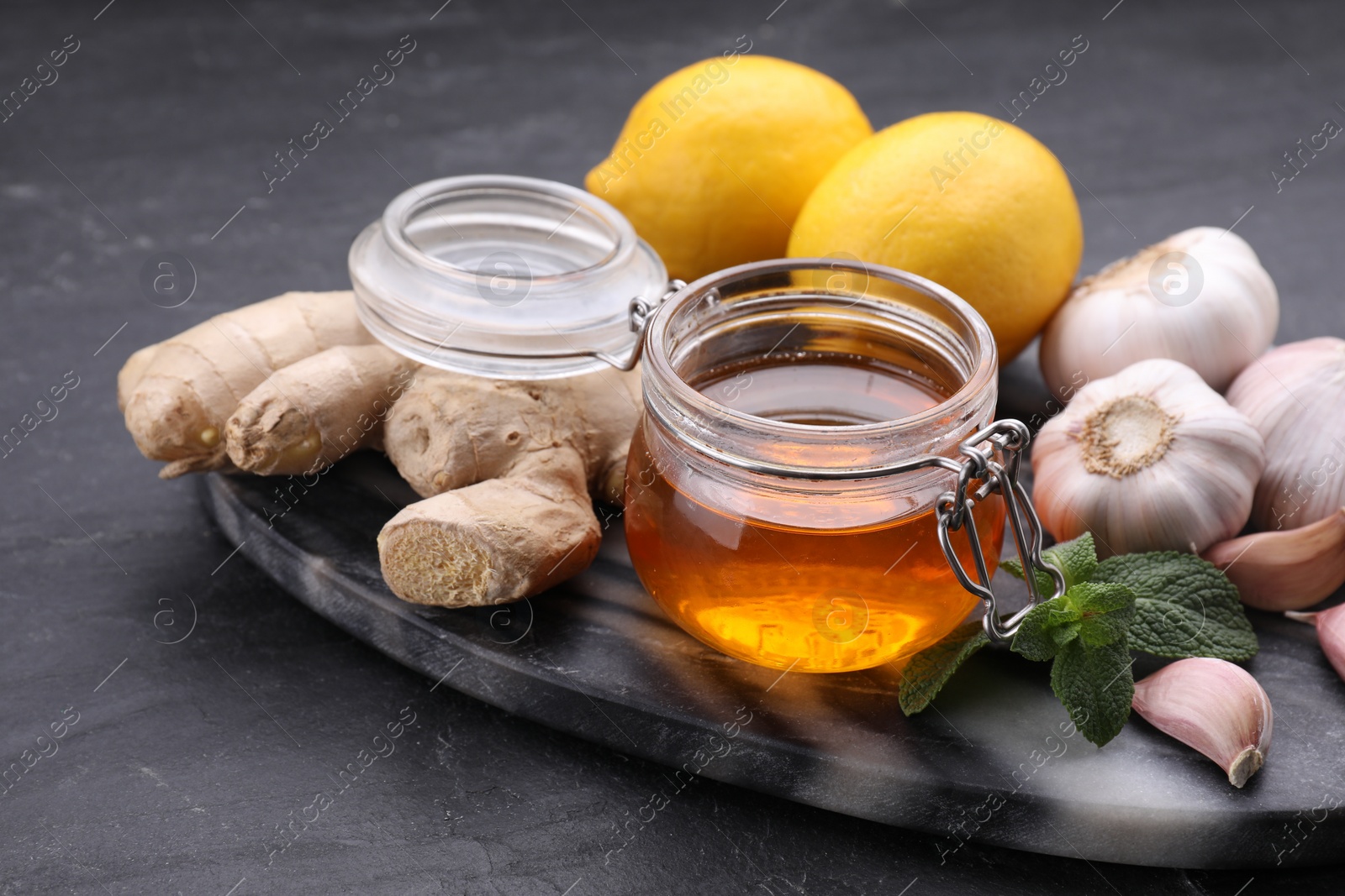 Photo of Cold remedies on black table, closeup. Cough treatment