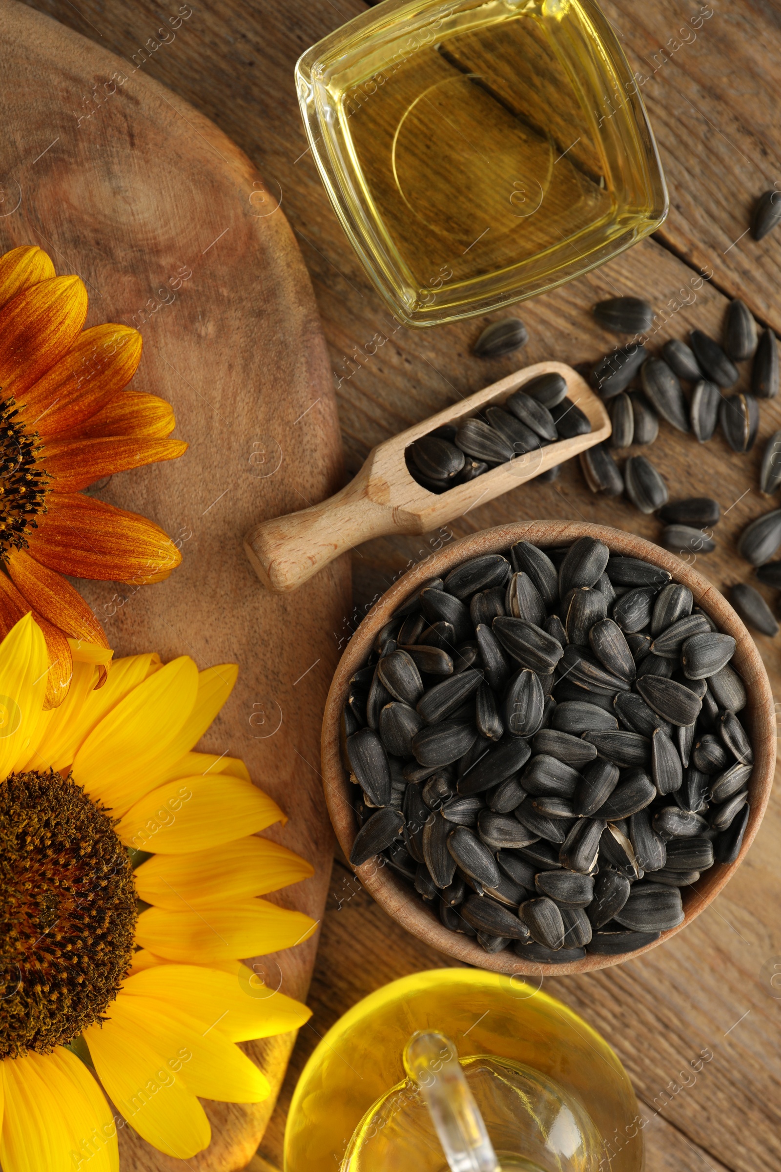 Photo of Flat lay composition with sunflower oil on wooden table