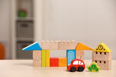 Set of wooden toys on table indoors, space for text. Children's development