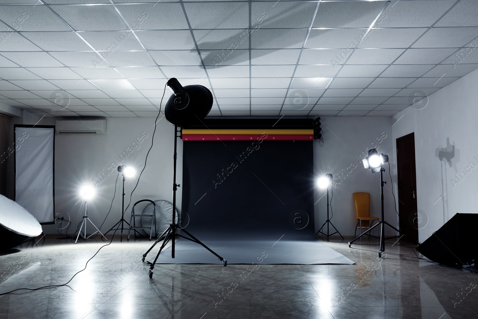 Photo of Interior of modern photo studio with professional lighting equipment