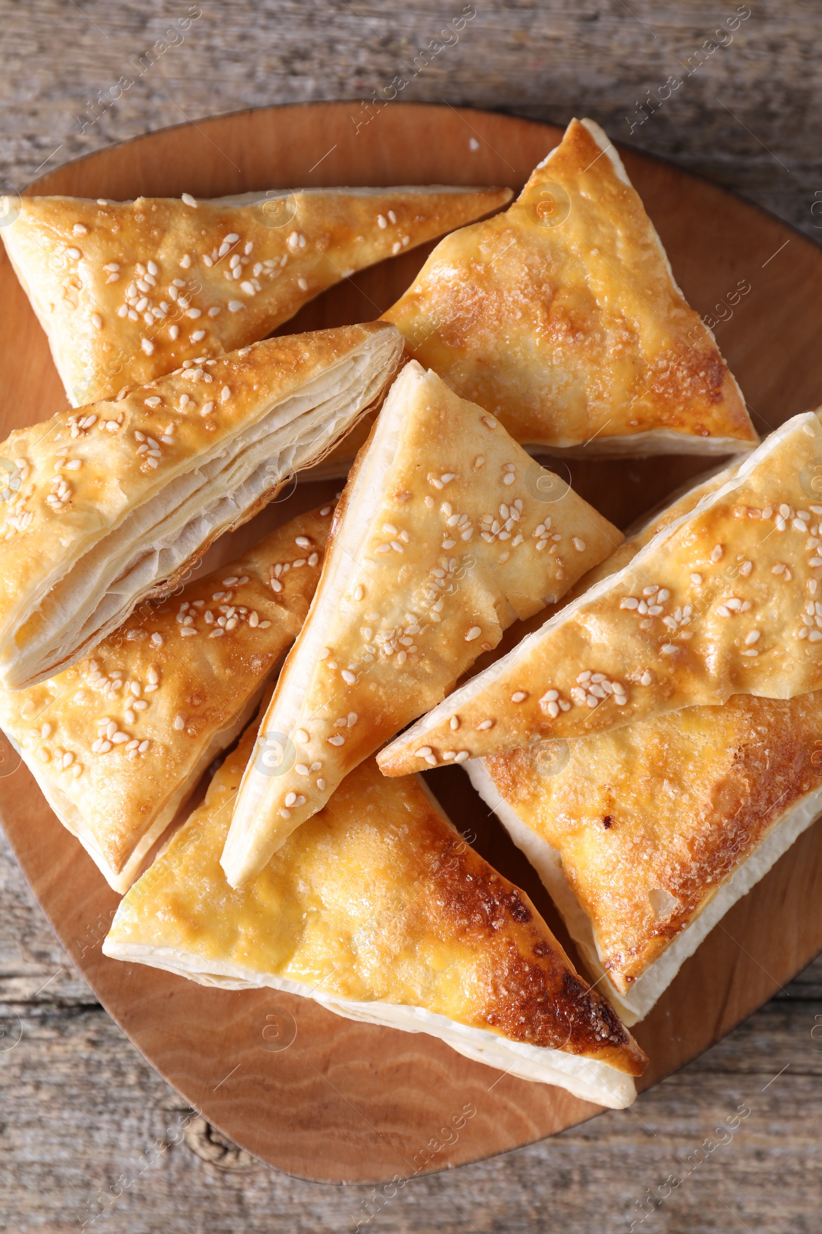 Photo of Delicious puff pastry on wooden table, top view