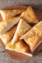 Delicious puff pastry on wooden table, top view